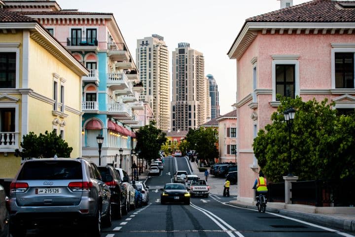 A vibrant street in Qanat Quartier, Pearl Island, Qatar—where European-inspired architecture meets modern urban life. The pastel-colored buildings, cobblestone-style streets, and elegant balconies create a charming, picturesque atmosphere in the heart of Doha.
